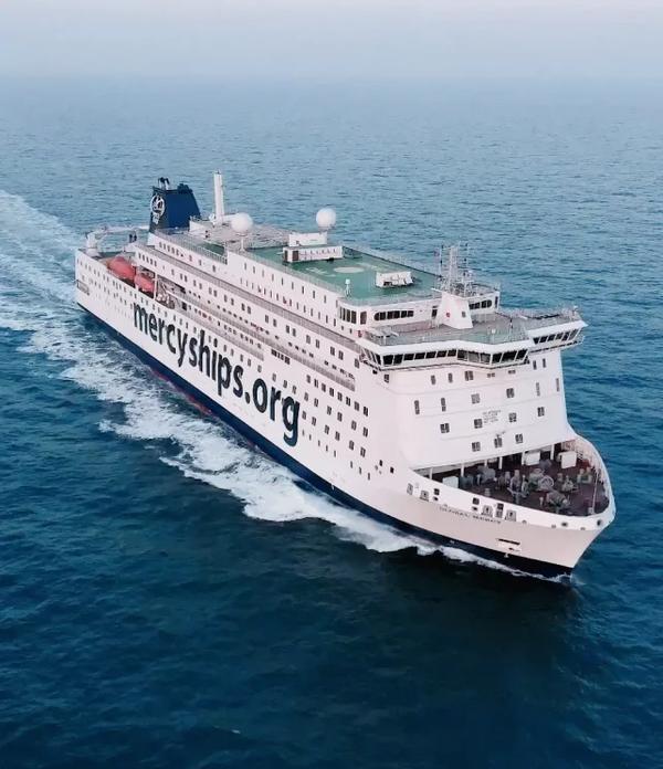 Aerial view of a Mercy Ships hospital ship at sea